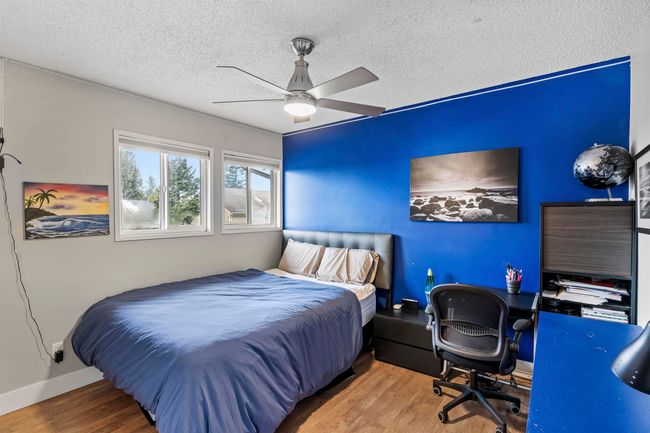 Bedroom with ceiling fan, a textured ceiling, baseboards, and wood finished floors | Image 15