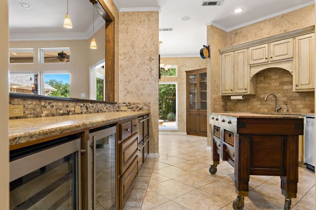 Kitchen with beverage coolers, refrigerated drawers, & granite tops | Image 7