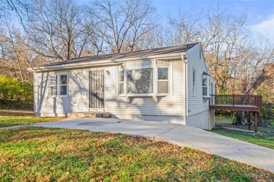 View of front facade with a deck and a front yard | Image 3