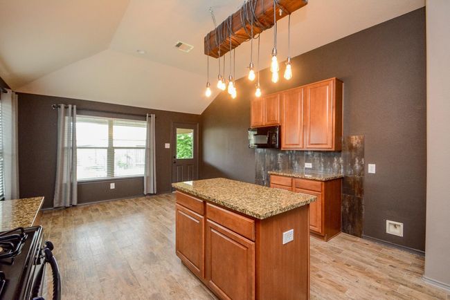 A custom light fixture illuminates the kitchen. | Image 13