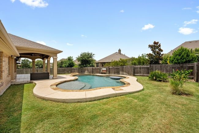 View of swimming pool featuring a fenced backyard | Image 30