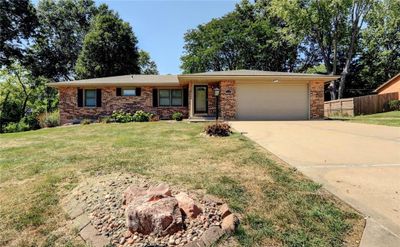 Single story home with a front lawn and a garage | Image 1