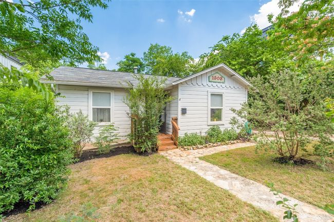 View of front of house featuring a front yard, board and batten siding, and a shingled roof | Image 12