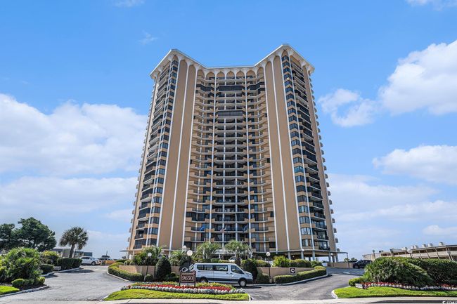 View of apartment building / complex featuring uncovered parking | Image 4