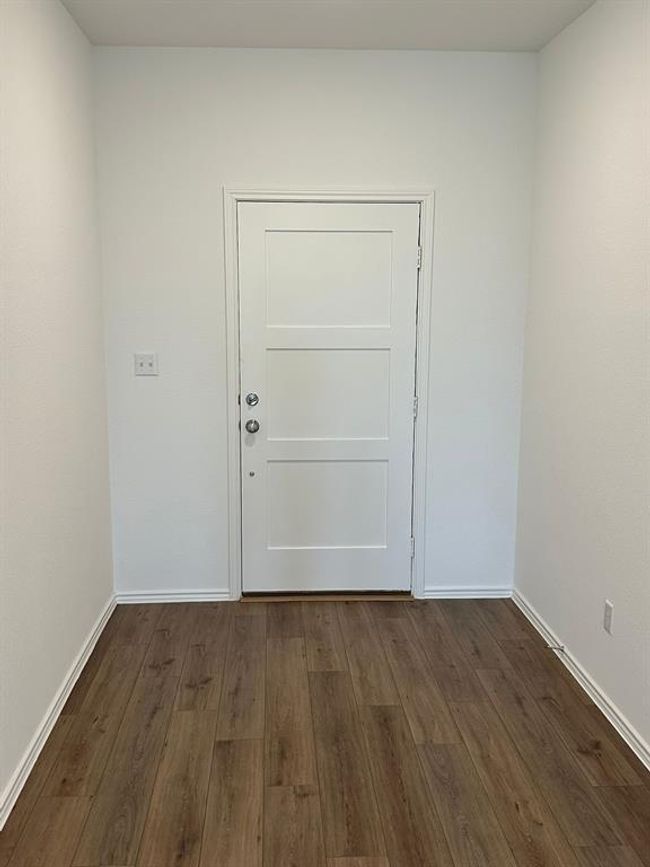 Doorway to outside with dark wood finished floors and baseboards | Image 6