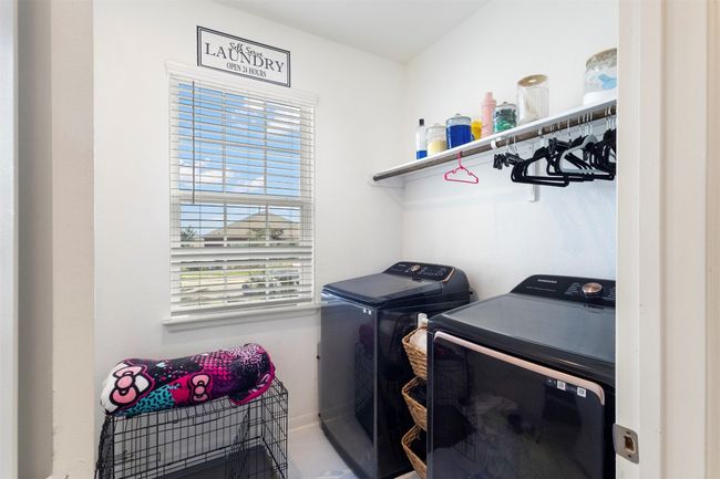 Washroom with separate washer and dryer and natural light | Image 5