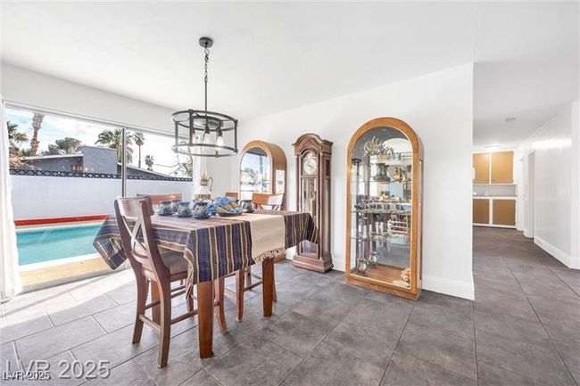 Dining room featuring baseboards and a chandelier | Image 11