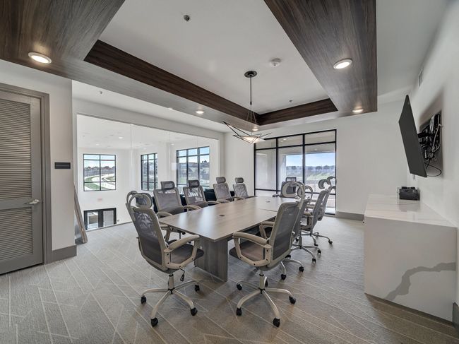 Carpeted home office featuring a tray ceiling, a healthy amount of sunlight, and baseboards | Image 22