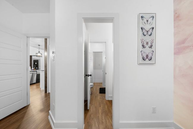 Hall with dark wood-type flooring and baseboards | Image 29