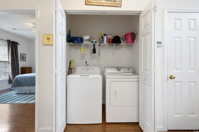 Washroom with washer and clothes dryer and dark wood-type flooring | Image 33