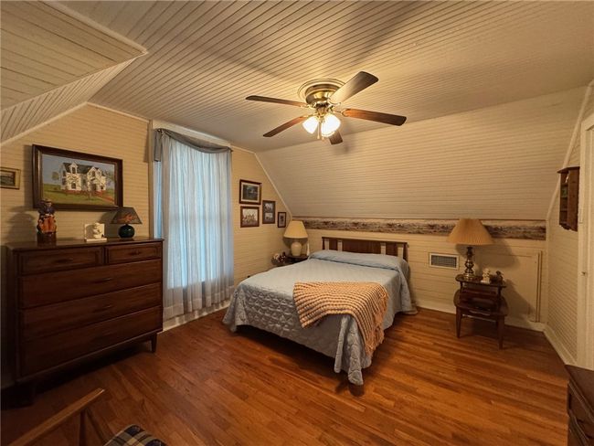 Bedroom featuring vaulted ceiling, dark wood-type flooring, wood ceiling, and ceiling fan | Image 27