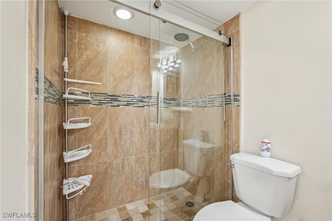 Bathroom with a shower stall and toilet | Image 20