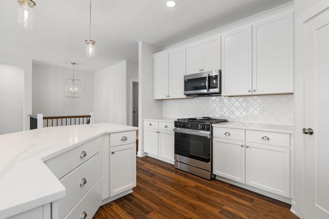 This stunning kitchen combines elegance and functionality, showcasing tall, beautifully painted maple cabinetry with soft-close doors and drawers for ample and seamless storage. | Image 18