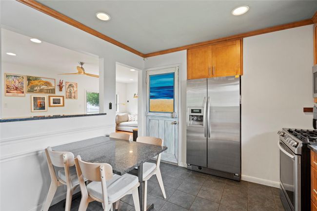 Dining area with ornamental molding, recessed lighting, and dark tile patterned floors | Image 14