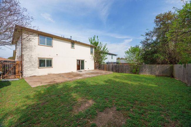 Rear view of house featuring a fenced backyard, a patio area, and a yard | Image 22