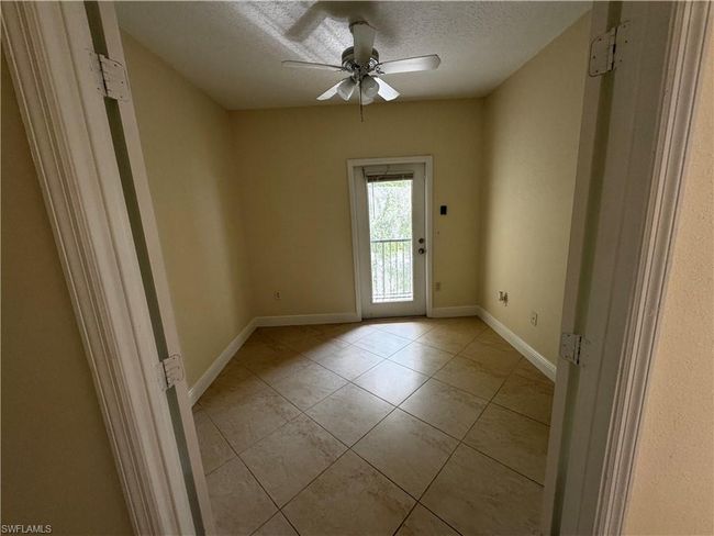Spare room with light tile patterned flooring, ceiling fan, a textured ceiling, and baseboards | Image 10