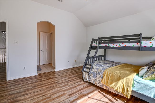 Bedroom featuring hardwood / wood-style floors and lofted ceiling | Image 34