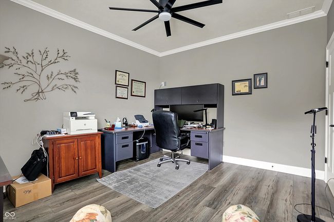 office with baseboards, wood finished floors, ceiling fan, and crown molding | Image 37