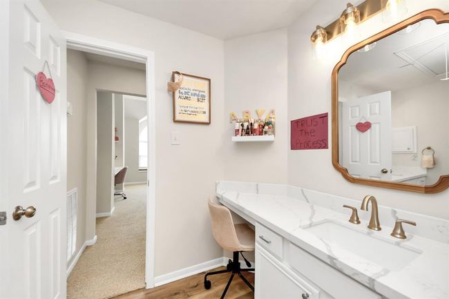 Another view of the spacious bathroom highlights the generous counter space and elegant faucet. You can also see the door leading to the flexible adjacent space, as well as the hallway connecting to the other secondary bedrooms. | Image 39
