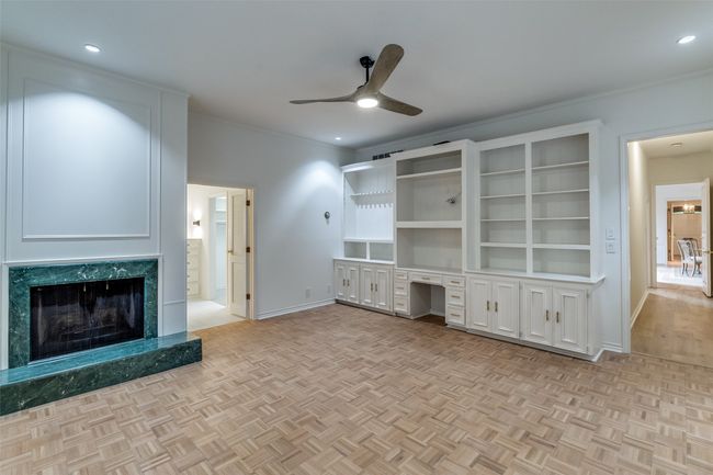Unfurnished living room featuring ceiling fan, baseboards, crown molding, a premium fireplace, and recessed lighting | Image 20