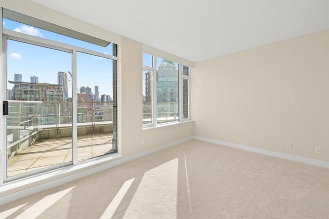 Carpeted spare room featuring a view of city, plenty of natural light, and baseboards | Image 8