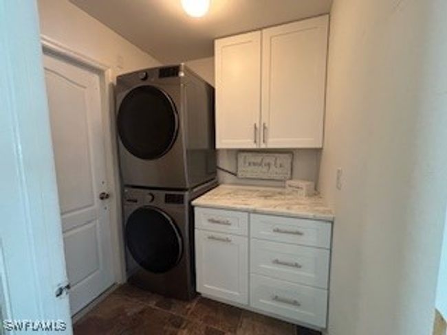 Clothes washing area with cabinet space and stacked washer / drying machine | Image 26