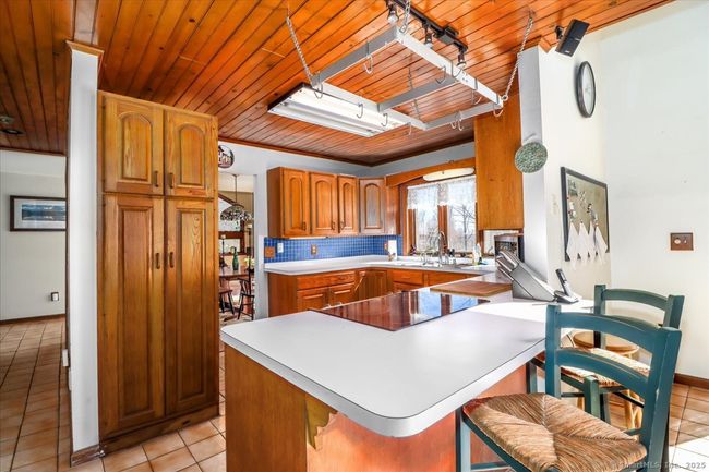 Your kitchen is open to the dining room and living room on one side and the den and sun-filled family room on the other side. | Image 13
