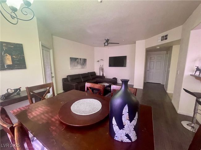 Dining space featuring visible vents, ceiling fan, baseboards, and wood finished floors | Image 18