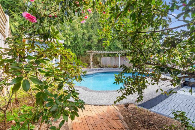 View of swimming pool with a patio, a fenced backyard, and a fenced in pool | Image 33