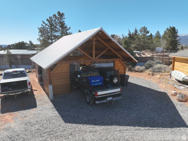 View of parking / parking lot with a carport and fence | Image 37