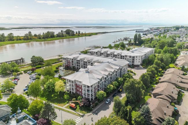 Aerial view of a large body of water and apartment complex | Image 38