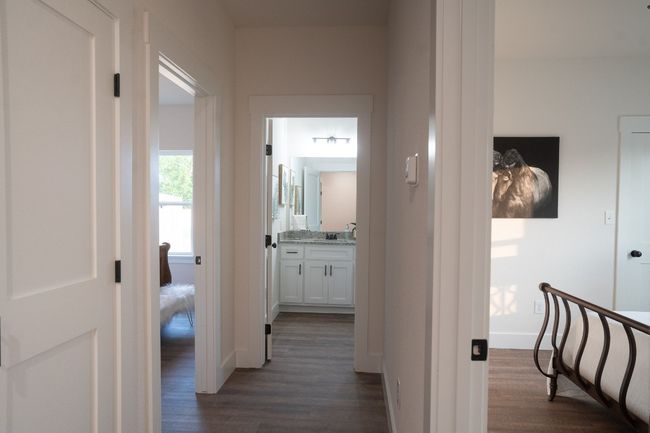 Corridor with dark wood-style flooring, a sink, and baseboards | Image 26