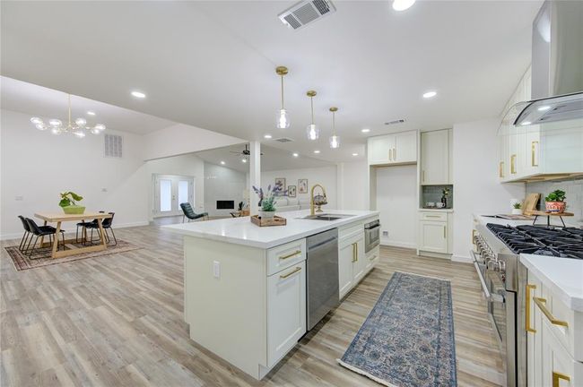 With an open flow into the living and breakfast rooms, this kitchen is designed for both functionality and style, making it perfect for cooking, entertaining, or simply enjoying everyday family life. | Image 13