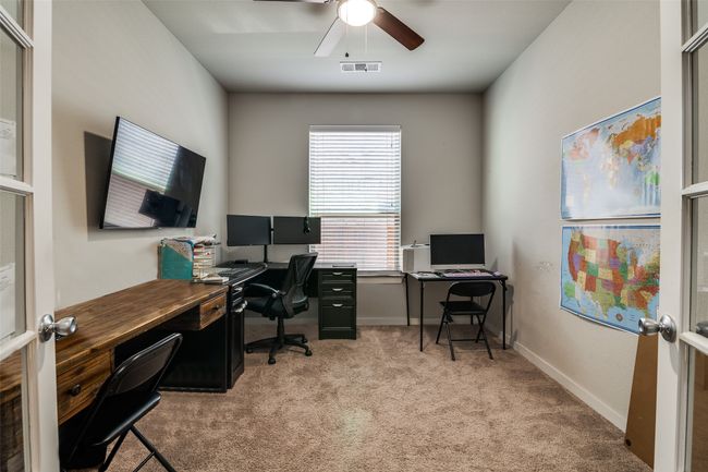 Office space with light carpet and ceiling fan | Image 5