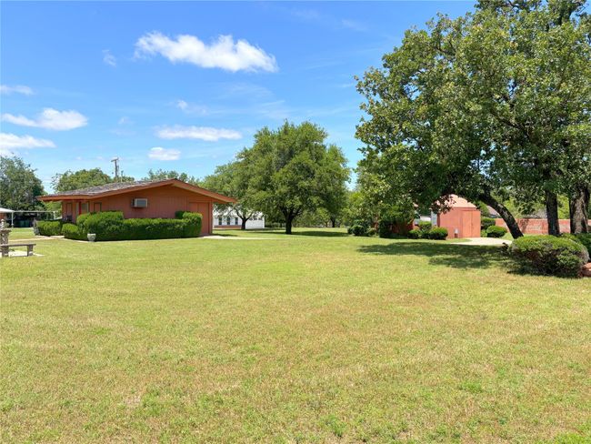 View of grassy yard featuring a garage | Image 12