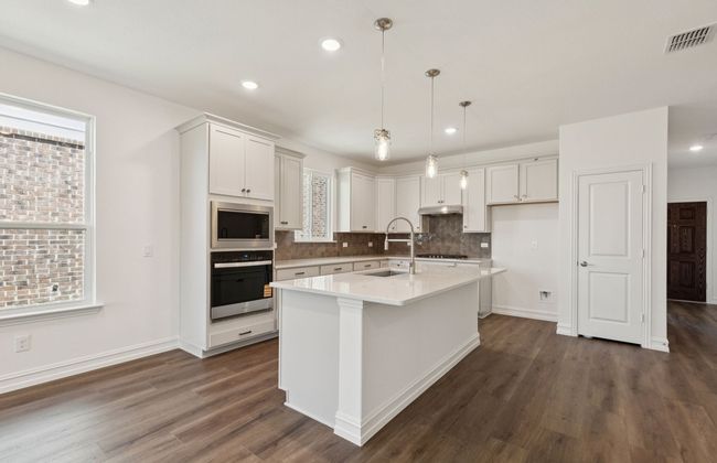 Kitchen featuring a large island ideal for informal dining and gatherings *Real home pictured | Image 6