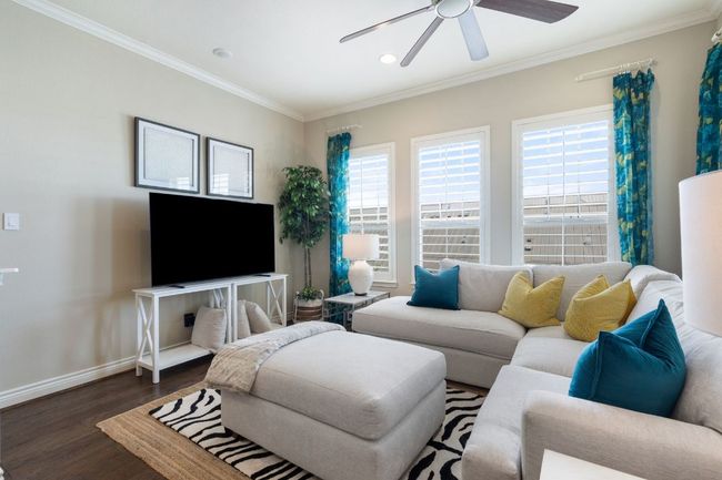 2nd Floor Living area with crown molding, lighting, dark wood-type flooring, a ceiling fan, and baseboards | Image 6