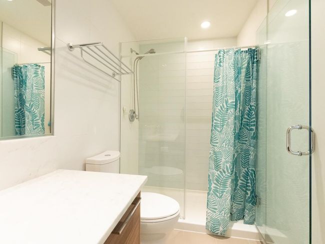 Bathroom featuring a shower stall, vanity, and recessed lighting | Image 13