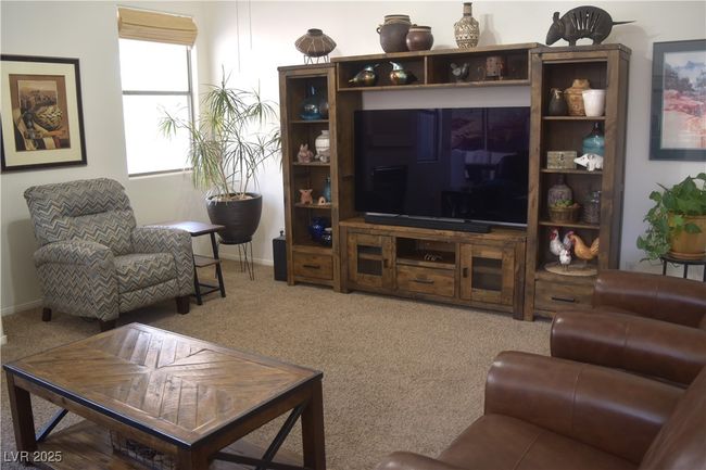 Carpeted living area featuring baseboards | Image 16