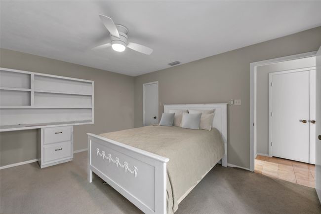 Guest bedroom offers tons of built-in cabinets and drawers - doubling as a fantastic home office space! | Image 23