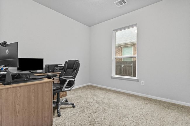 Carpeted home office featuring baseboards and lofted ceiling | Image 29