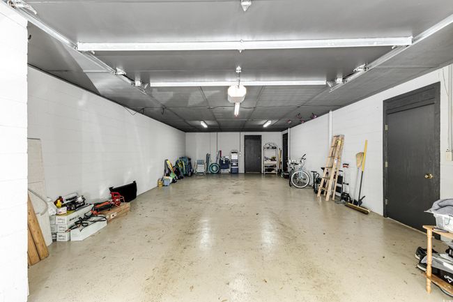 Garage featuring concrete block wall | Image 26