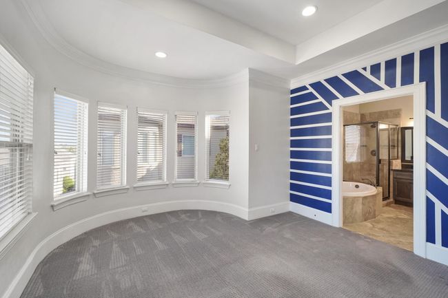 Primary suite with bay window sitting area. | Image 14