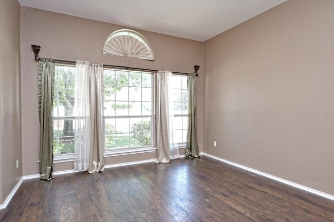 Unfurnished room featuring dark wood-type flooring and baseboards | Image 5