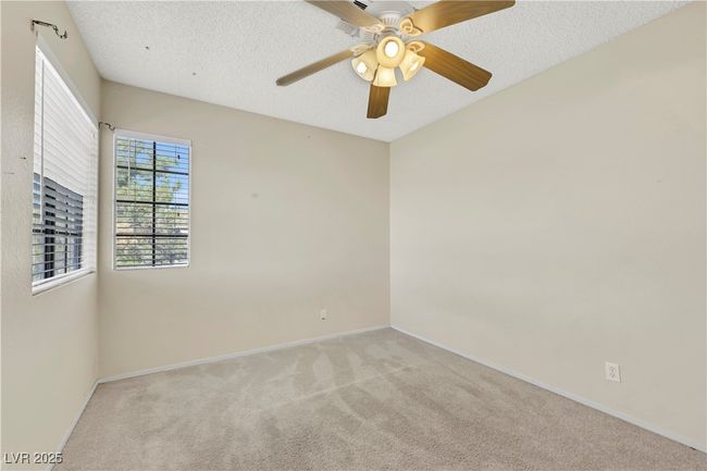 Unfurnished room with light carpet, ceiling fan, a textured ceiling, and baseboards | Image 35
