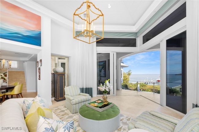 Living room spans the home with pocketing sliders out to the patio & bay views too | Image 12