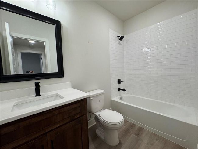 Full bath with wood finished floors, vanity, and shower / bathtub combination | Image 55