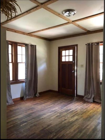 Entryway featuring a healthy amount of sunlight, coffered ceiling, and dark hardwood / wood-style flooring | Image 2