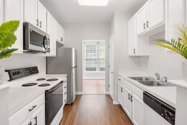 Sleek and stylish modern kitchen design with bold black hardware accents. | Image 13
