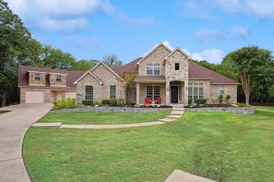 View of front of home featuring a front lawn and a garage | Image 1